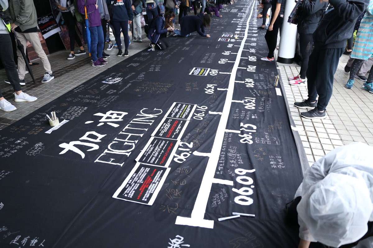 rachel_cheung1's tweet photo. At the Day and Night of #HongKongProtesters Rally at Edinburgh Plaza, a long black cloth is laid out, recounting every day during the #antiELAB movement since the first march on June 9. A description is attached to symbolic days such as 6/12, 7/21, 8/31. https://t.co/QTwCAM7VhY