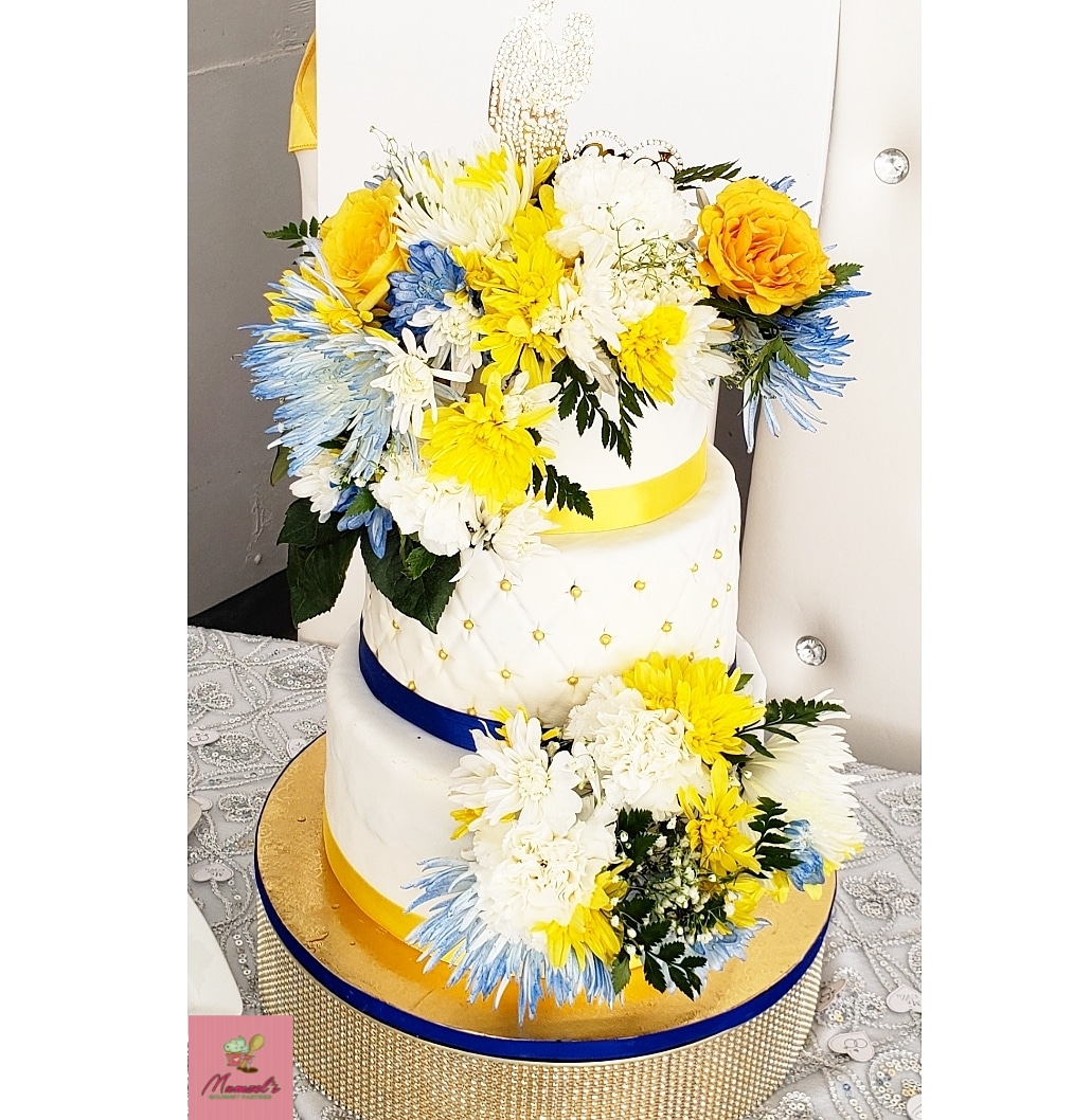 Mumzels's tweet photo. Our final cake for 2019 was a STUNNER! 💛💙💛 😍 Congratulations Mr. &amp; Mrs. Wright. #BakedWithLove. #MadeFromScratch. #3TieredCake. #WeddingCake. #JamaicanFruitcake. #FondantCovered. #RealFlowers. #SweetsAndBakes. https://t.co/2l0qEaPeIT