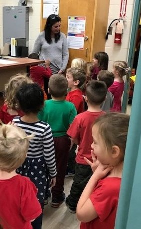 Kindergartens sharing a song of kindness with Mrs. Hunter in the office!