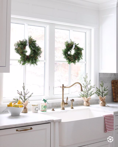 WaterstoneUSA's tweet photo. We love the use of these #TraderJoes wreaths as window decor and check out that Annapolis faucet! So festive! https://t.co/l4qia9wNP1