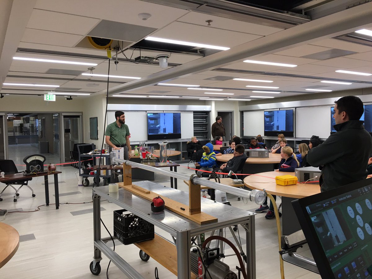 DavidHammond19's tweet photo. The group du jour was from CP Smith School, 5th grade. A really great group of students.  Very engaged and many good questions. Luke Donforth pictured in the background, the ping-pong ball cannon and Juan Vanegas in the foreground. Physics in the round, a great space! https://t.co/DMCJsmnUHT