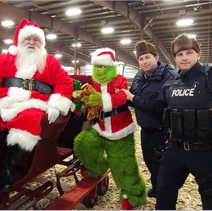 RCMPAlberta's tweet photo. Cst. Nick Harper and Cst. Michael Hagel arrested the Grinch last Saturday in #Lloydminster on theft-related charges. He was released into Santa Claus’ custody after apologizing for stealing #Christmas. https://t.co/5qprCIbfJF