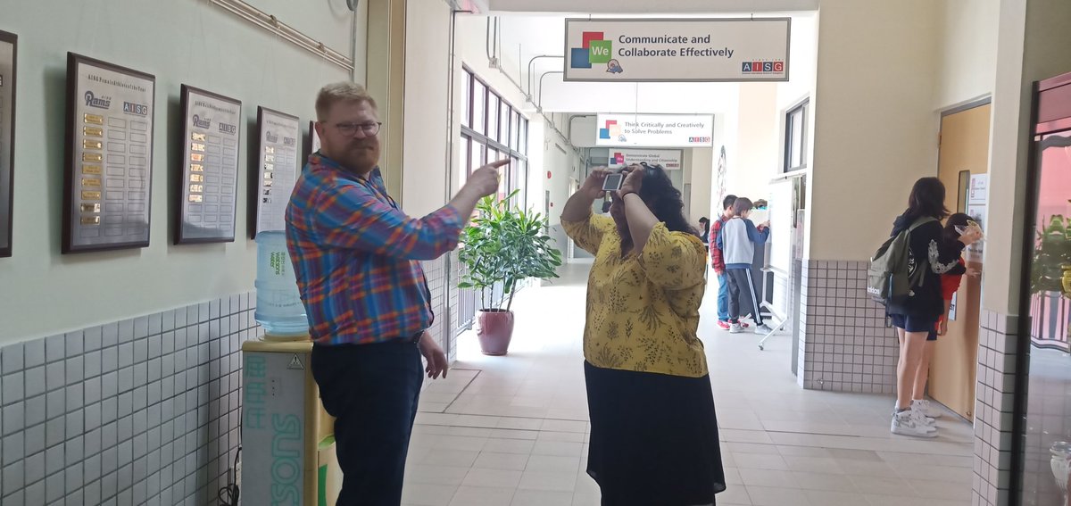 zee_oh_ee's tweet photo. It's the last week of school before #WinterBreak and two of my favorite people at @AISGZ are playing #HeadsUp in the halls during lunch. #RamNation keeping it fun and festive before break! Happy Holidays everyone!! @Ms_Siemens @johnjkennett https://t.co/rnVzmTSipV