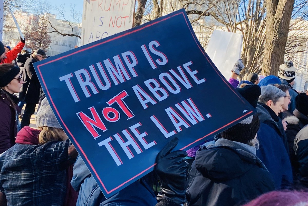Sign reads “Trump is not above the law.”