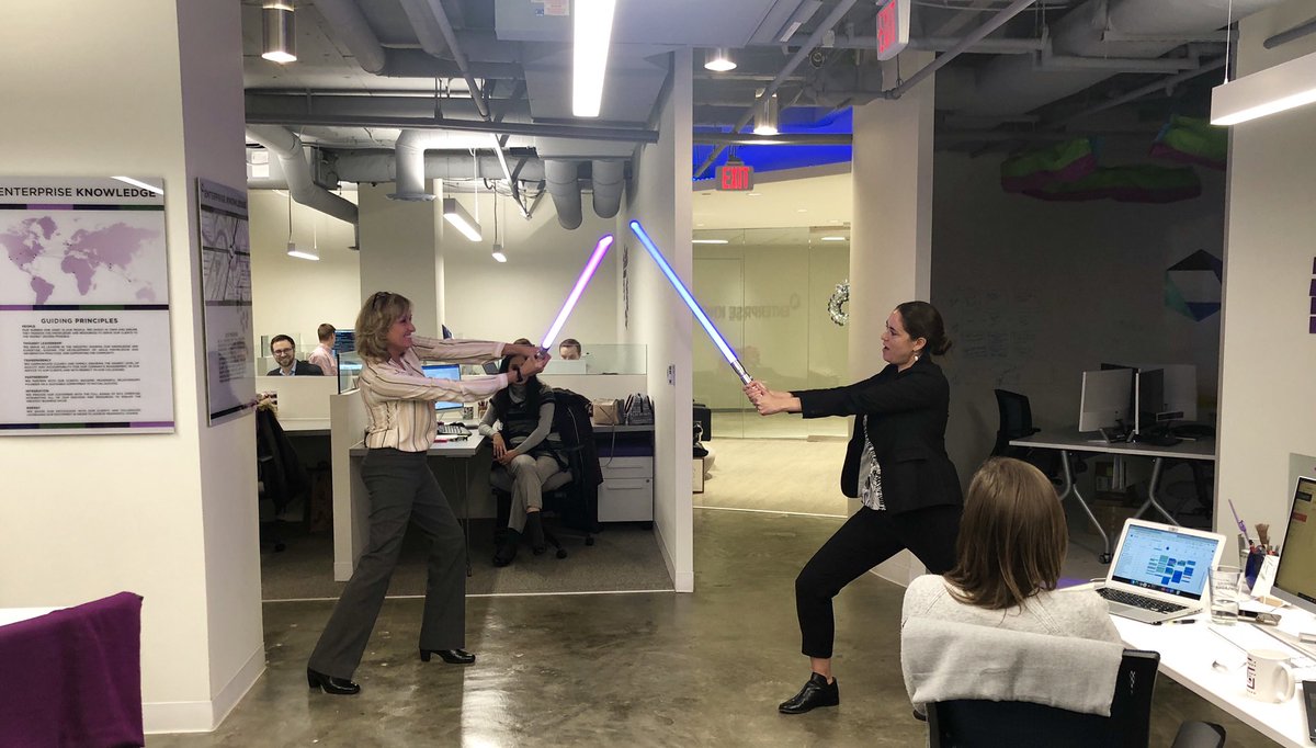 Deneena and Rebecca celebrating a new win with EK’s lightsabers.
