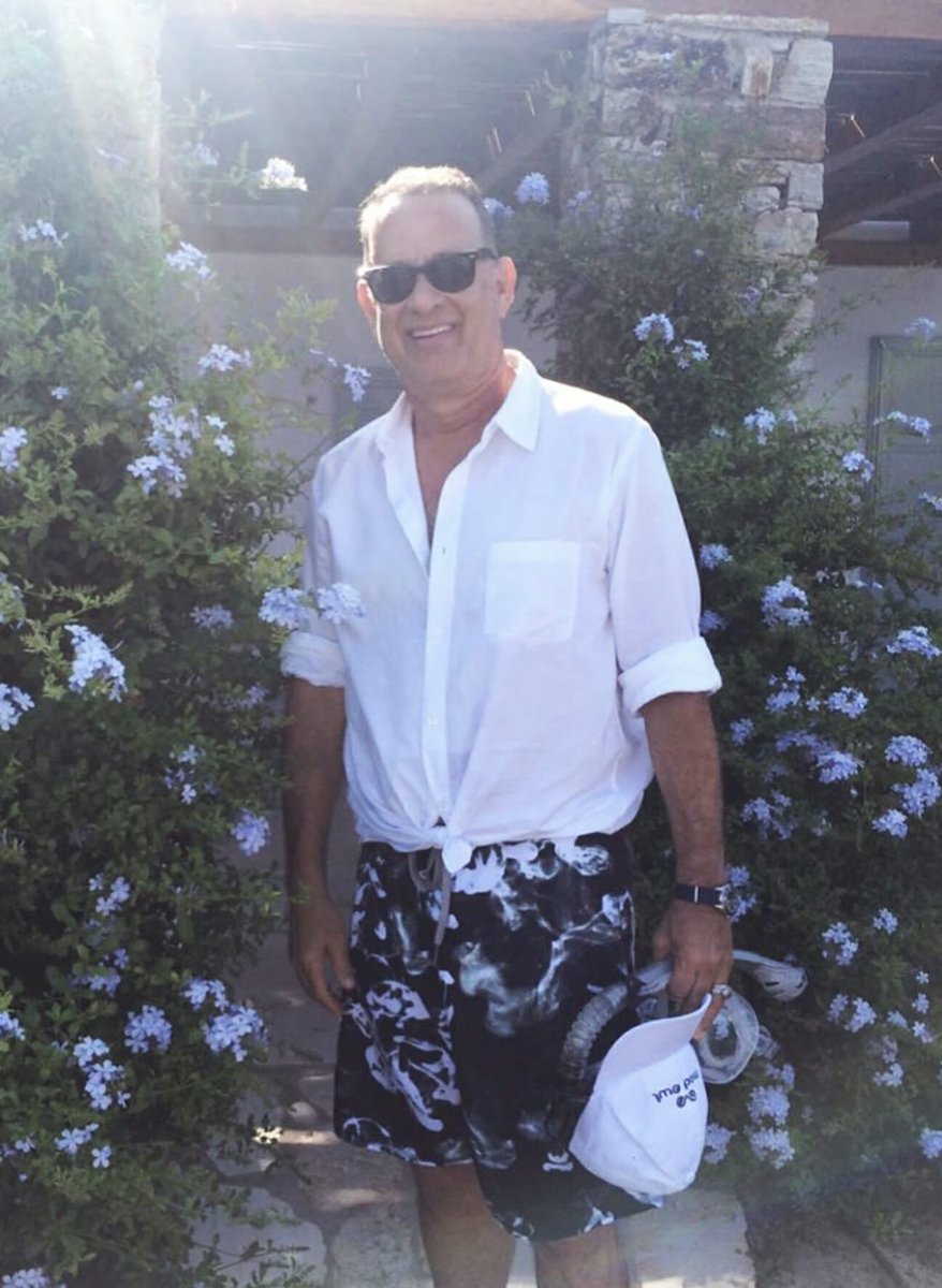 in His free time - Tom Hanks likes to STOP and smell the roses. What a cutie pie