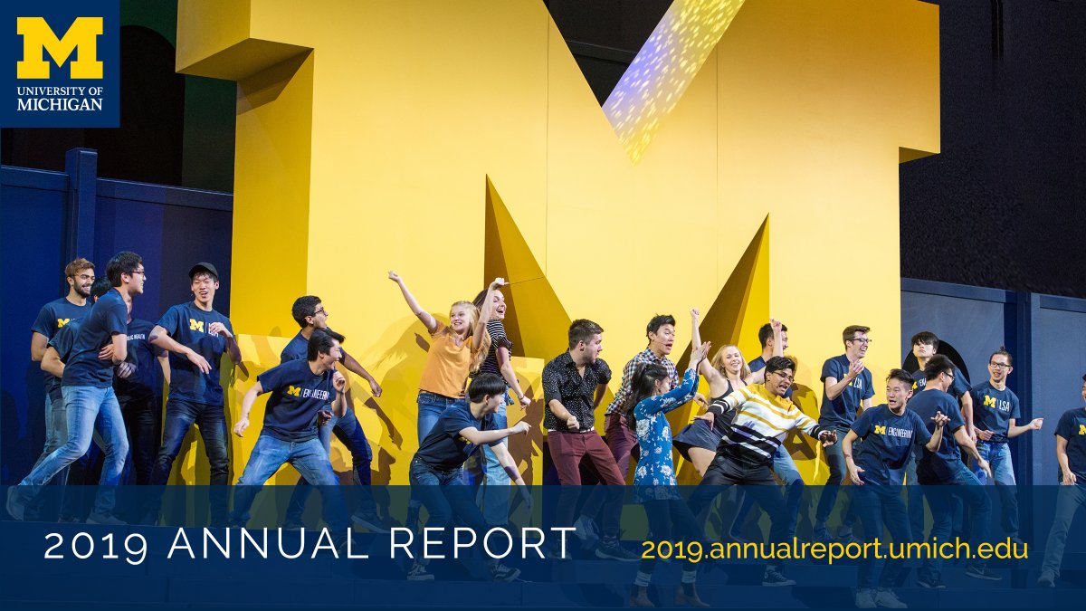 Students dance in front of a large Block M.