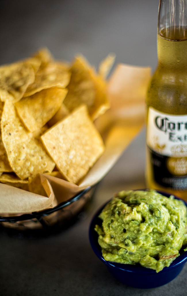 Don't skip the dip. Chips and fresh house-made guacamole pair perfectly with Coronas! #Cheers #HelloBettyOS #StarterPack #Oceanside