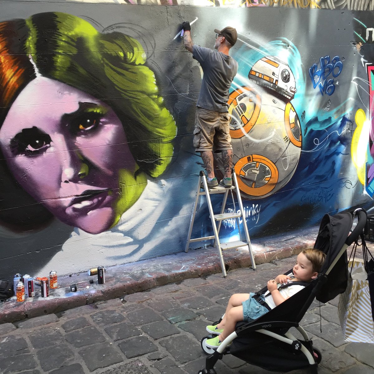 iamclare's tweet photo. My other half, #stevecross painted this in Hosier Lane a few years back, when the first new #StarWars came out. That’s my son, being tiny and cute, in the foreground. ❤️ https://t.co/Dp0OVfm4Cm