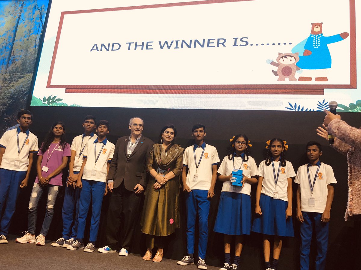 Young students lined up under a sign that says “and the winner is…”