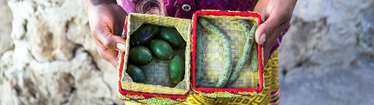 A peasant holds baskets with seeds in his hands
