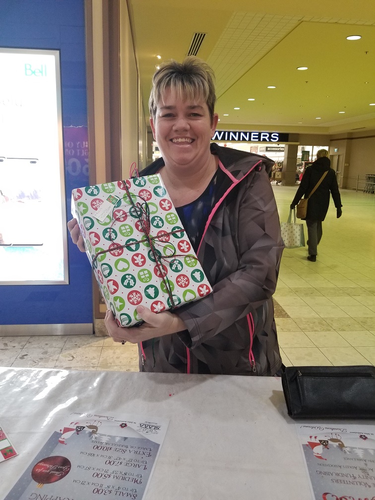 CherreyBusLines's tweet photo. And another happy Christmas shopper.  The Cherrey Bus Lines staff and Robin Hood staff  participated in wrapping gifts for donations to local Stratford causes. https://t.co/meiAWRo5o4