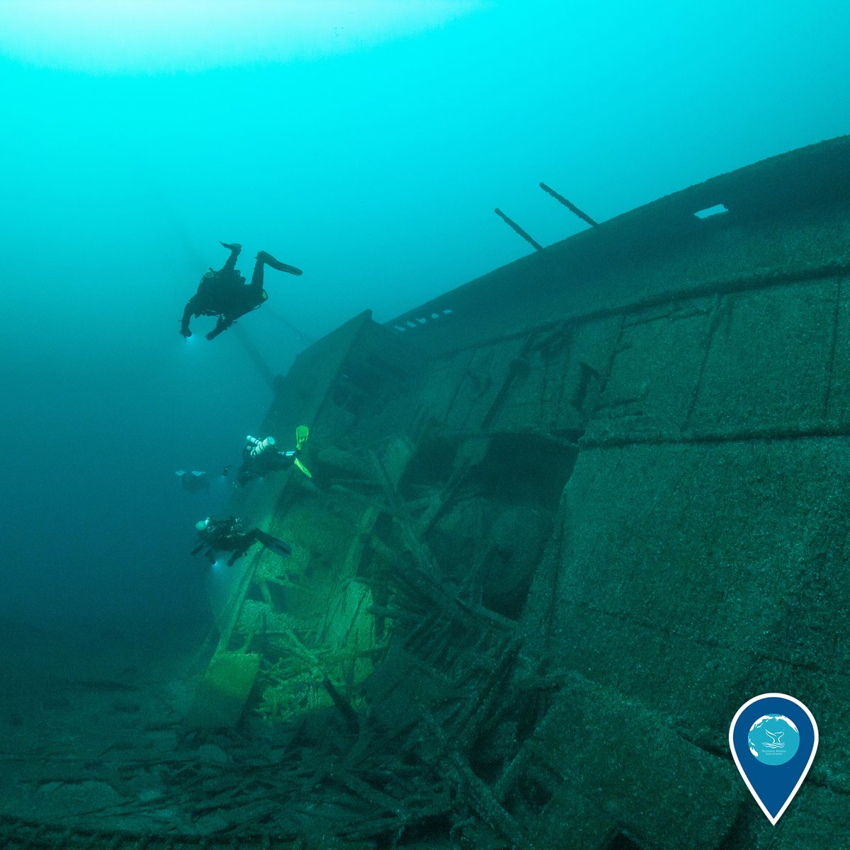 divers exploring a shipwreck