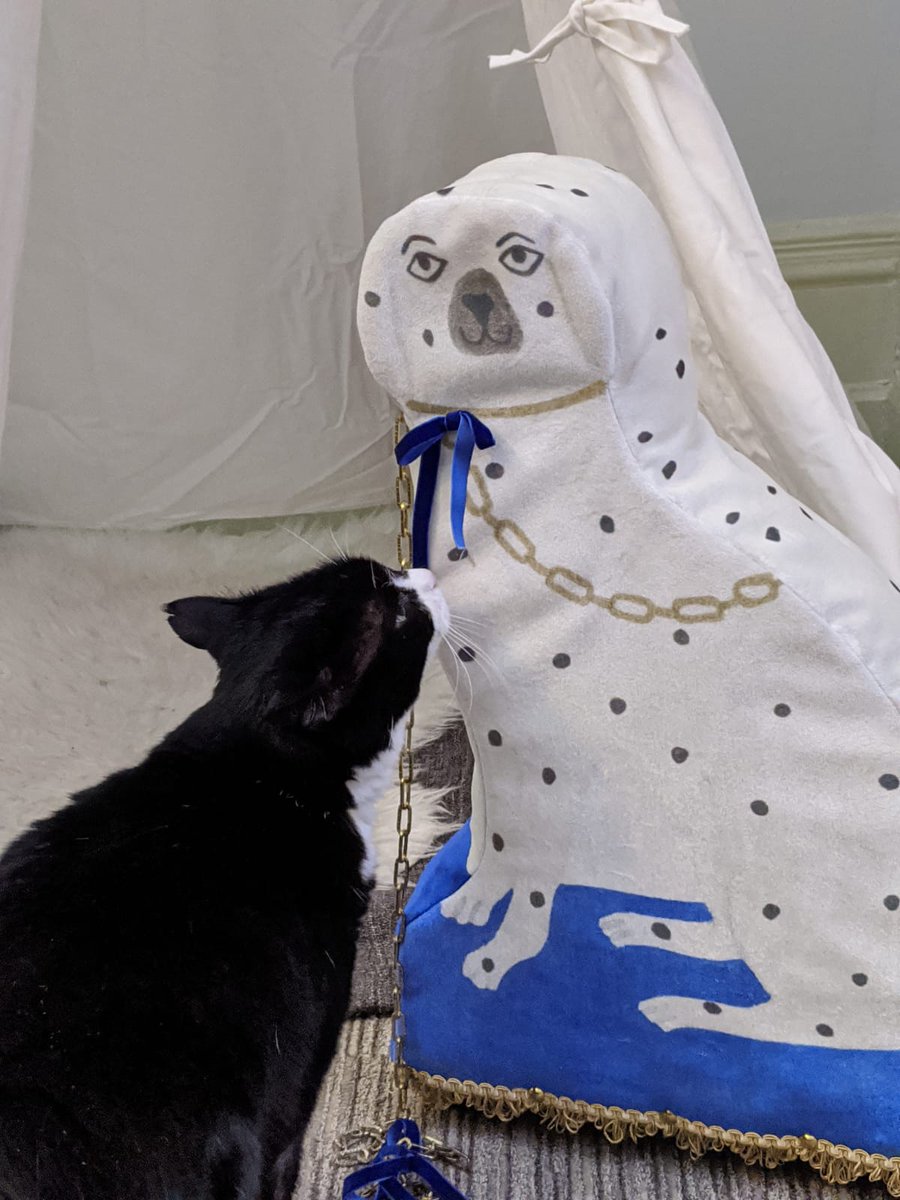 Palmerston sniffing around a model of a white dog!