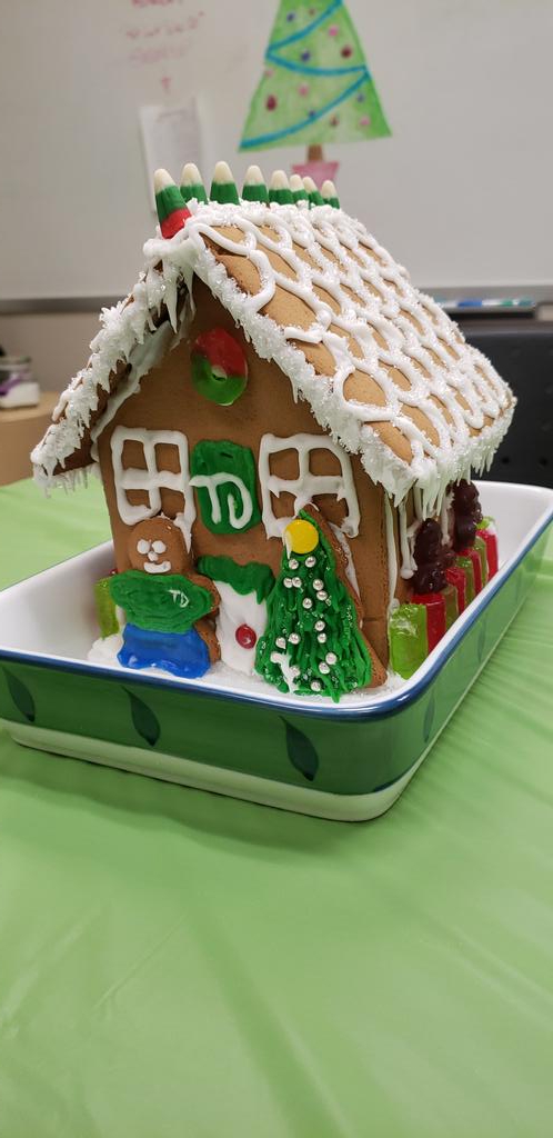 ElisaJMR's tweet photo. 3312 is having a potluck and Nat has made us the cutest gingerbread house! (She never forgets her TD pin!) @jackline_TD https://t.co/YGGs5FSNAv