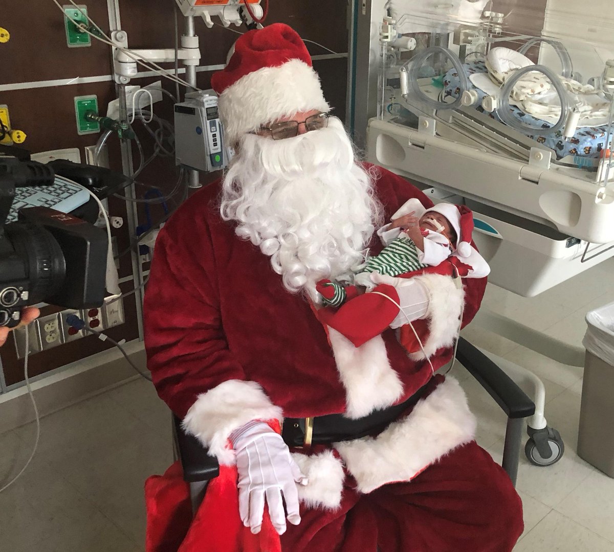 BHLexington's tweet photo. Babies at Baptist Health Lexington NICU had a big surprise today when Santa came to visit. Here, Santa holds Zakarie, son of Constance Hughes. Notice Zakarie's tiny Santa hat! See WKYT and WLEX this afternoon and tomorrow's Lexington Herald-Leader for more about this special day. https://t.co/OA7R5PW82H