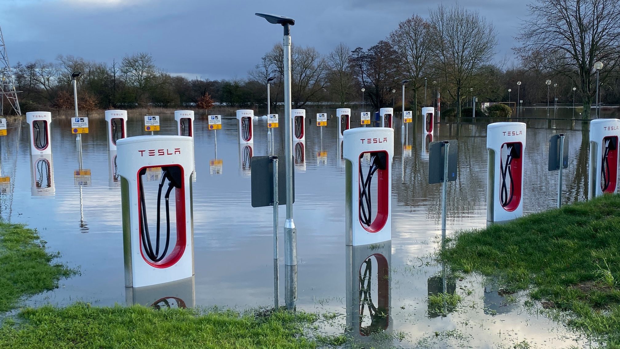 Megan Baynes on Twitter: &quot;Possibly one of the most striking pictures of the  flooding I've been sent — the Tesla electric vehicle stations in Wokingham  are now underwater. I feel like there