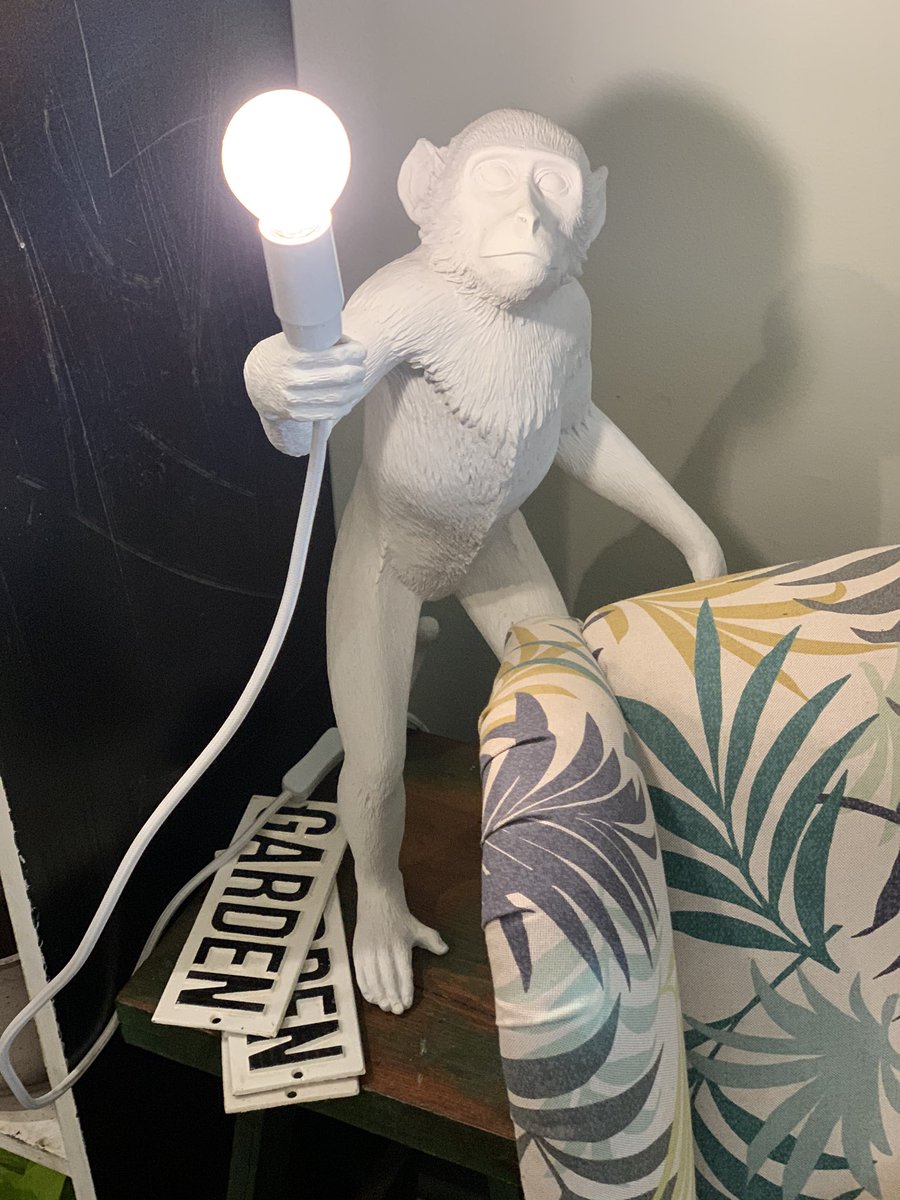 A monkey statue holding a light