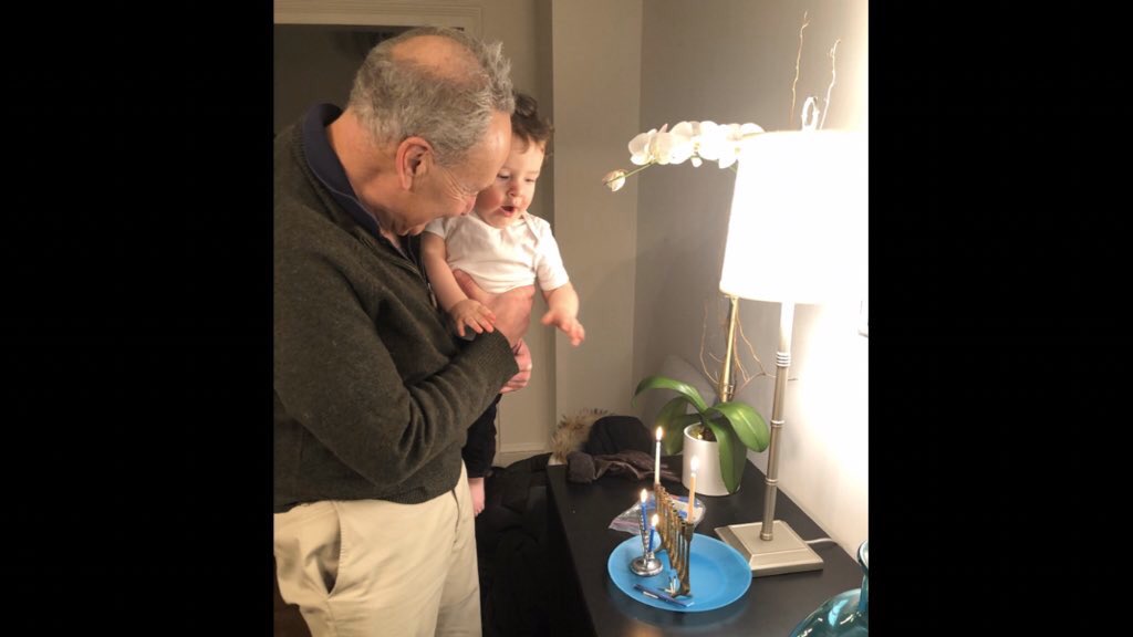 Senator Schumer and his grandson Noah with a menorah on the first night of Hanukkah.