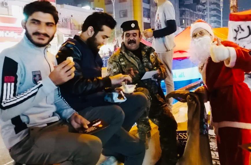 TimesIraq's tweet photo. Santa Claus is celebrating Christmas holiday with Iraqi protesters in Al-Tahrir square in Baghdad.
#IraqProtests https://t.co/sRYhvydZnN