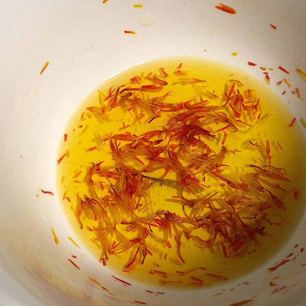 showing off of wealth was involved.) Here is safflower I bought today, & the dye it started releasing after a few seconds of steeping. It was labelled "saffron" in Arabic and English, & the buyer is expected to know from the price which is which. Old texts would be no different.