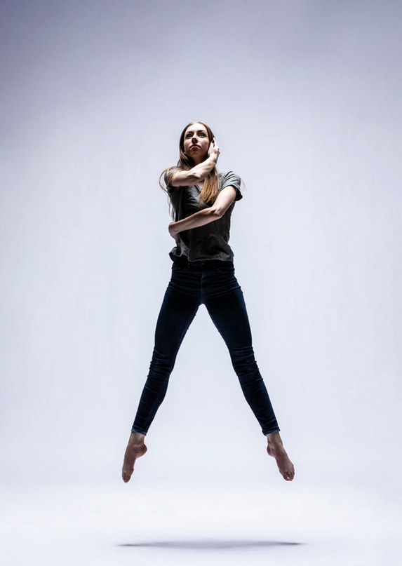 Woman leaping in dance photo shoot.