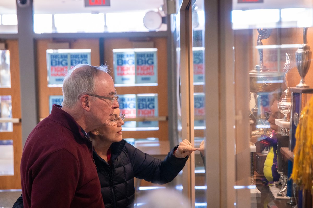 Elizabeth Warren and her husband Bruce look at her high school debate trophy.