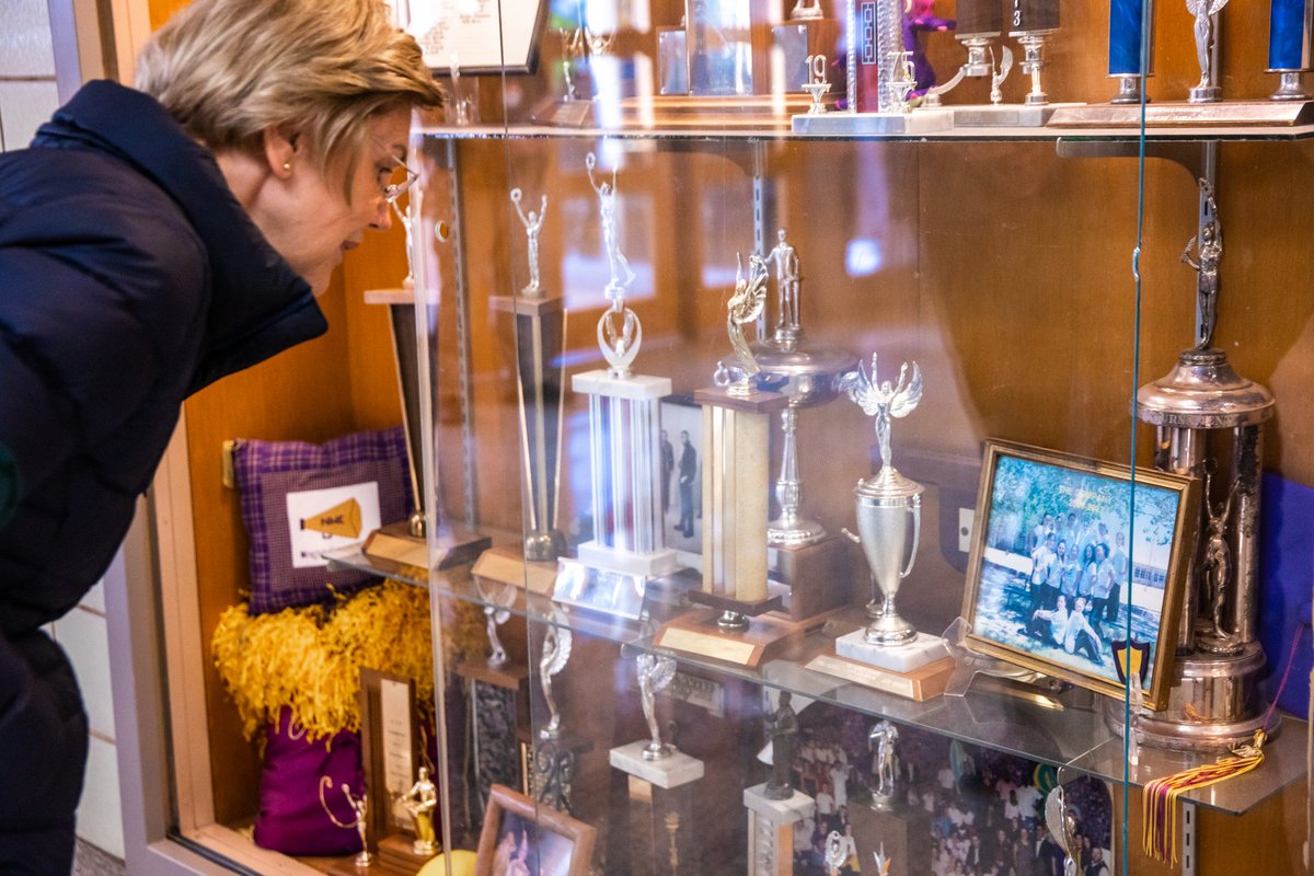 Elizabeth Warren looks at her high school debate trophy.