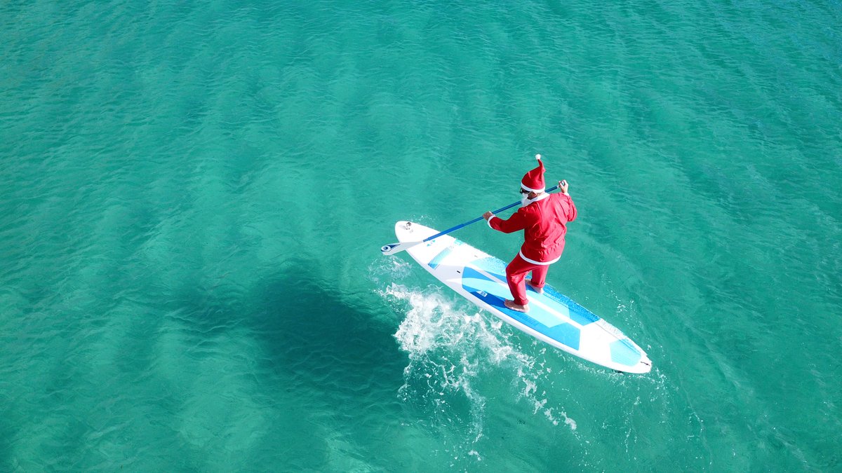 Father christmas paddleboarding