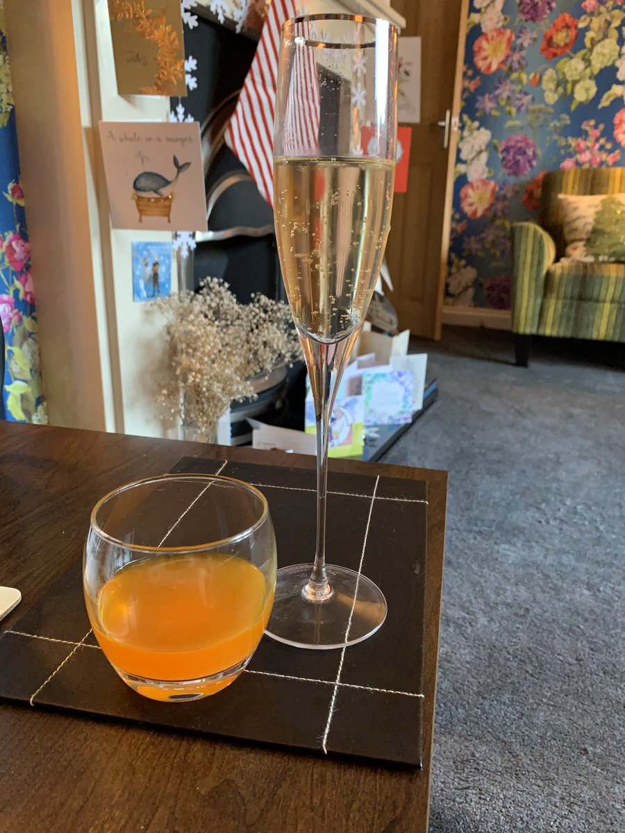 A glass of champagne and a vitamin C drink
