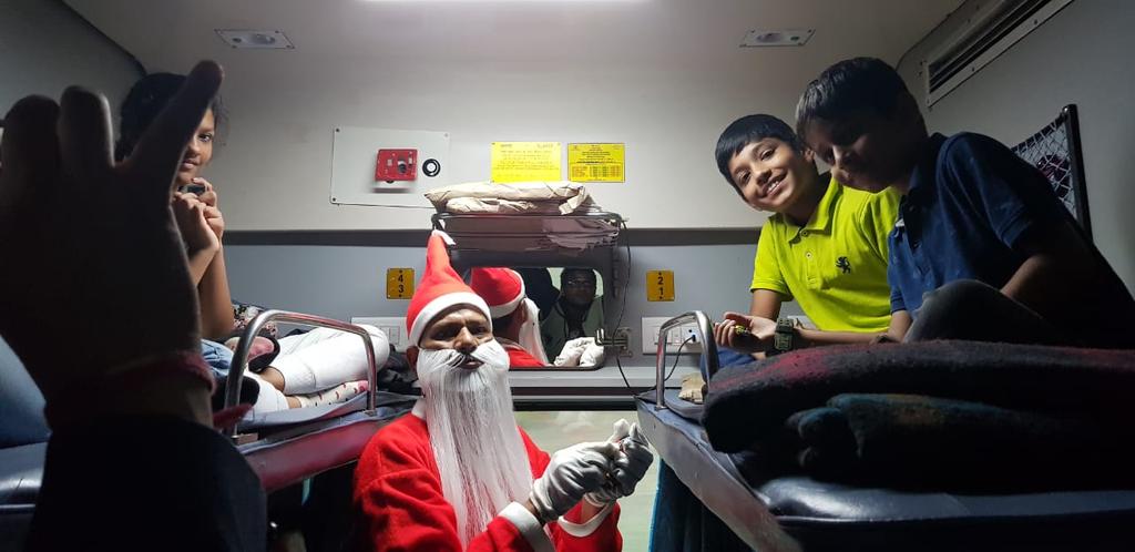 andya_k's tweet photo. Thanks @indianrail @indianrailway__ for making our journey special today. Santa paid a surprise visit. @piyushgoyaloffc https://t.co/L2OgyYcCJy