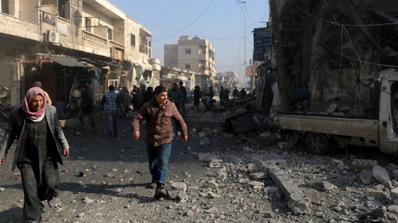 DukaKofi's tweet photo. People are seen around the debris of buildings after air raids carried out by Syrian government forces in Idlib https://t.co/GckDwTFTiS