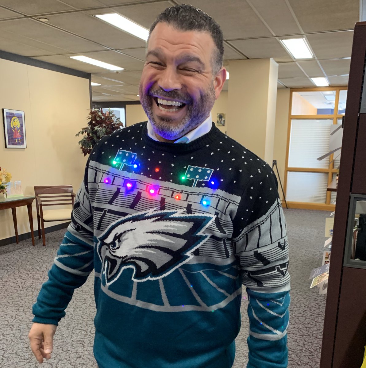 Secretary Rivera wearing a Philadelphia Eagles football sweater in office