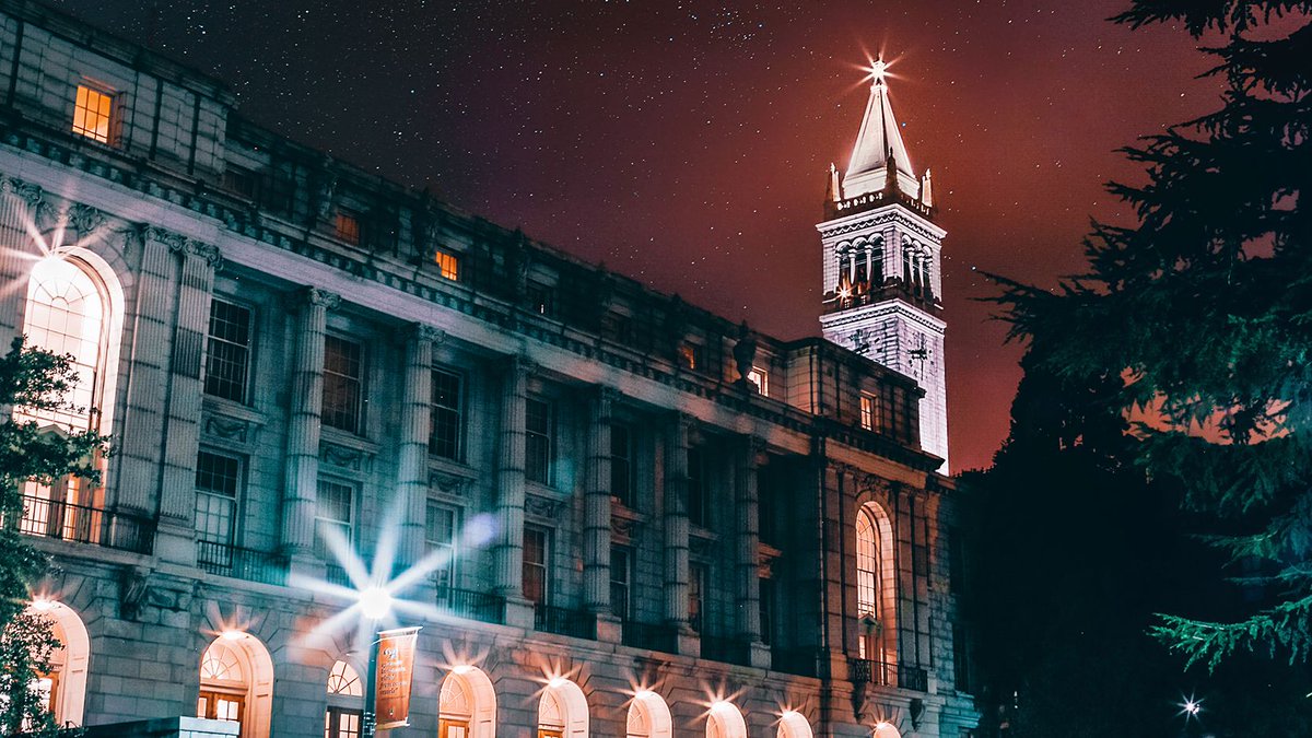 Wheeler hall and the campanile lit up with lights