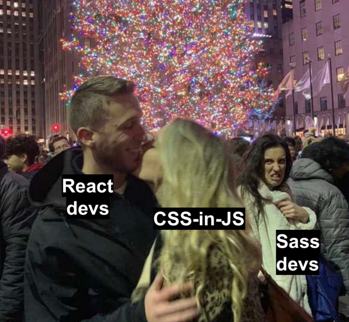 React devs kissing CSS-in-JS in front of a giant Christmas tree. Sass devs in the background looking disgusted.