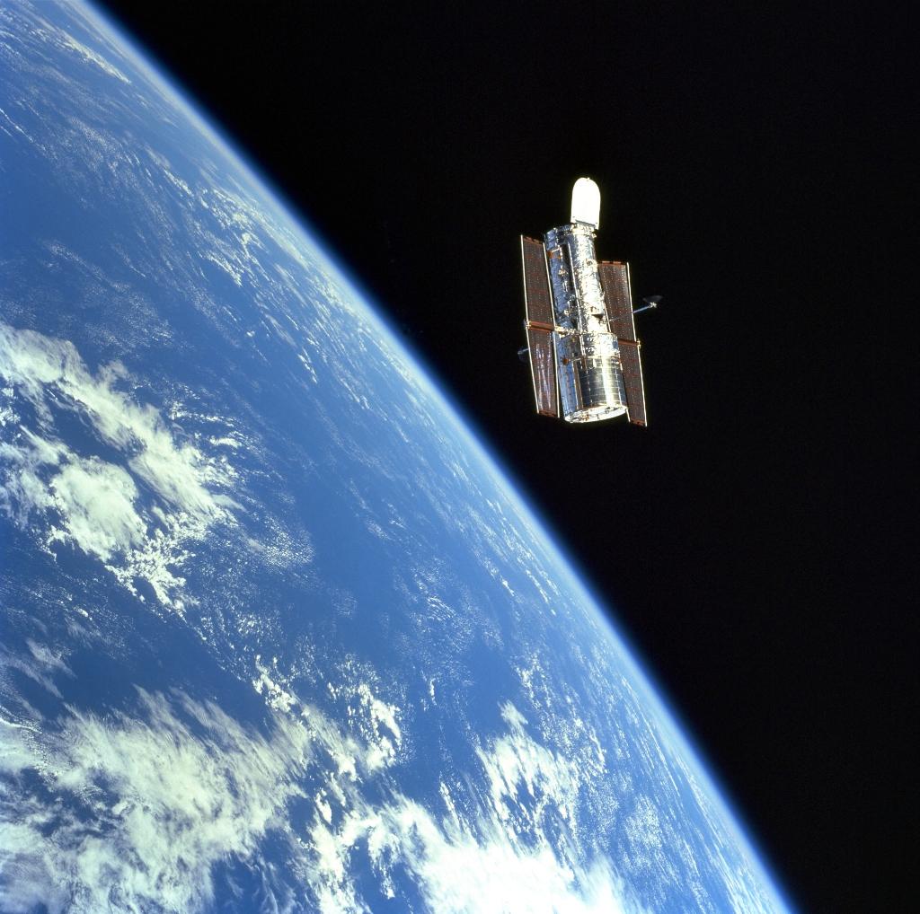 NASAHubble's tweet photo. #Now in 1999, astronaut Jean-Francois Clervoy uses the shuttle's robotic arm to gently release the Hubble Space Telescope back into orbit to continue its quest to unravel the secrets of the universe. #SM3A https://t.co/rSrnIpTKHp