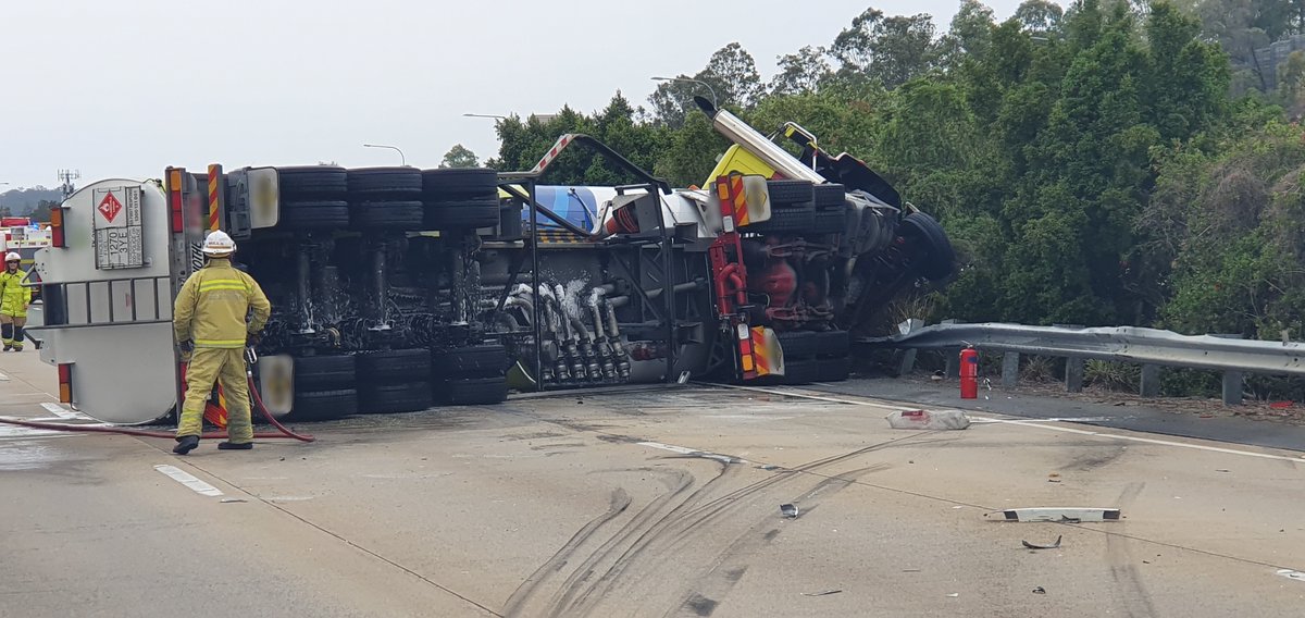 QldPolice's tweet photo. Police declare emergency situation on M1 at Helensvale after fuel tanker crash. M1 blocked in both directions, please avoid the area. https://t.co/PR0Q8E3M7B https://t.co/rSe8diA2KS