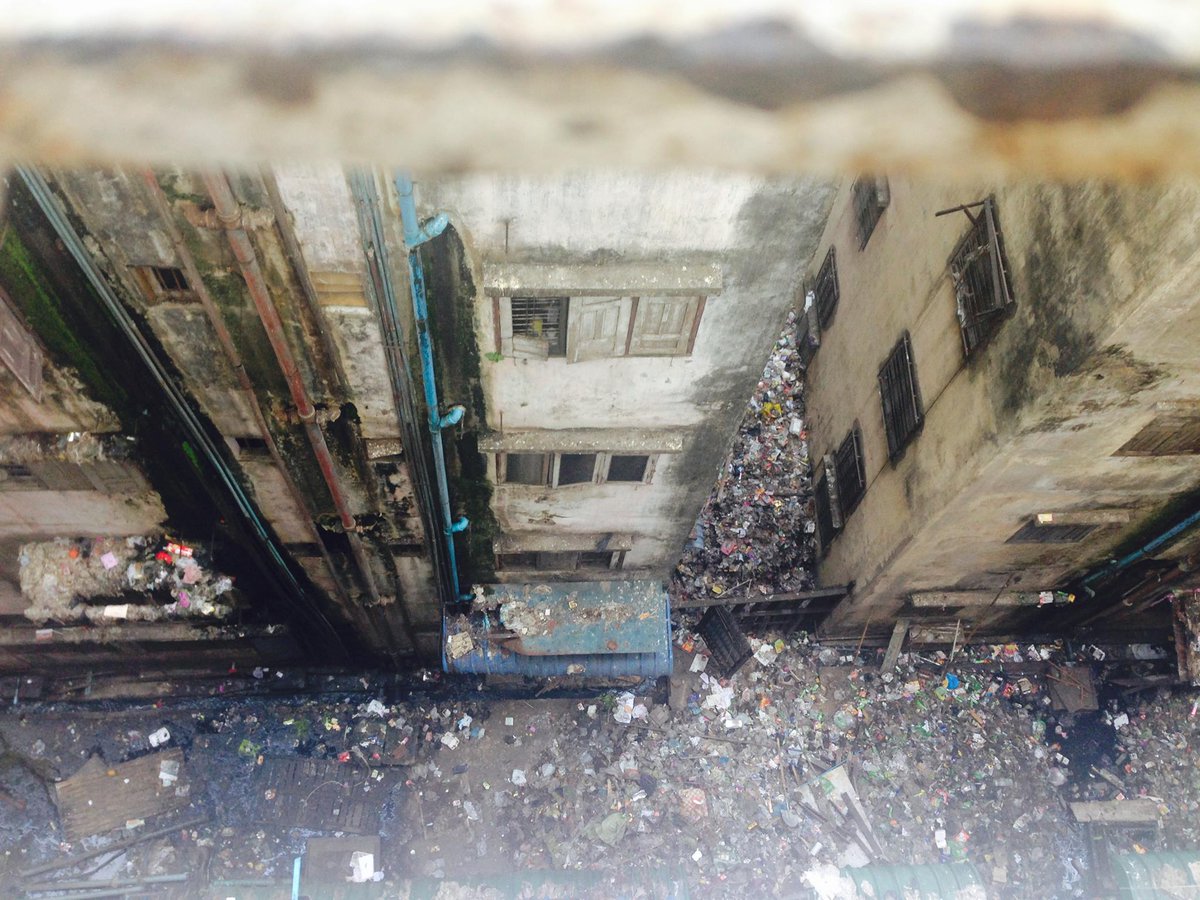 By the time I moved back to Yangon in 2015 and lived briefly in one of the downtown apartments, they were in horrible shape. The one behind our flat (pic below) has garbage that must be feet-deep. It was a health & environmental hazard. (4)  #trash  #cities  #yangon  #burma  #myanmar