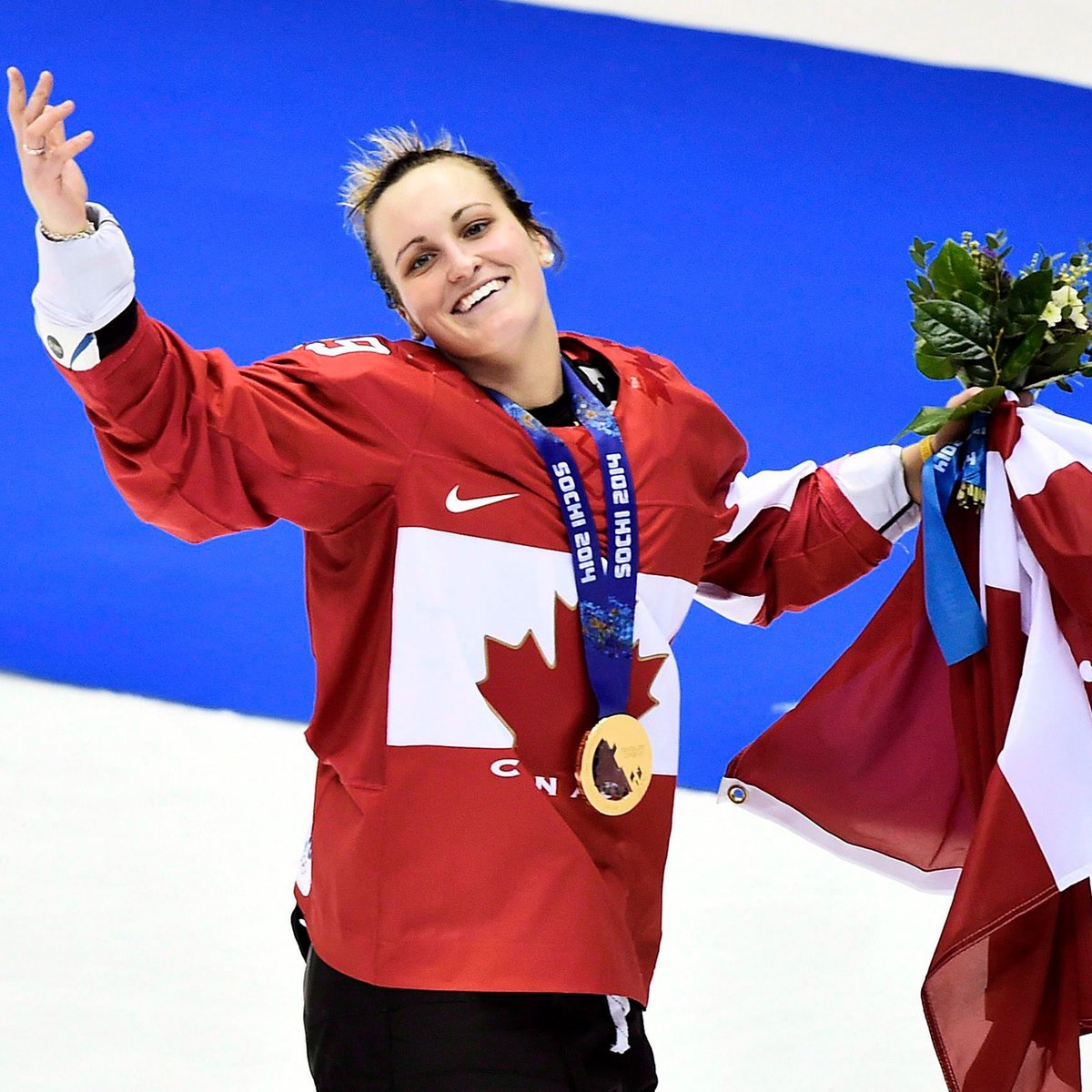 Marie-Philip waves to the crowd after winning gold at Sochi 2014.