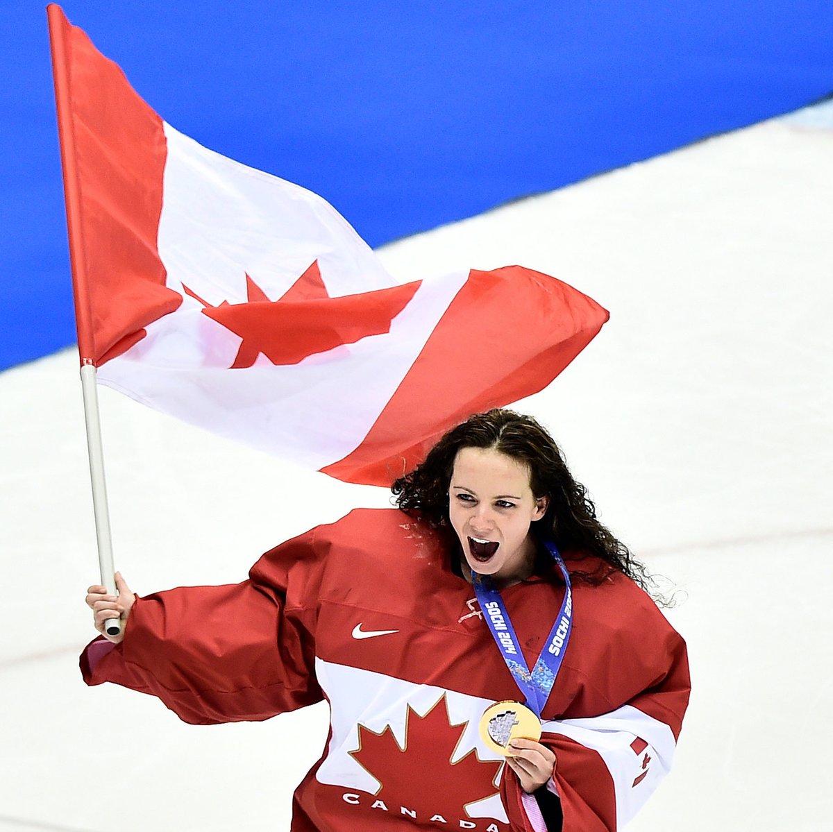 Shannon waves the Canadian flag after winning gold at Sochi.