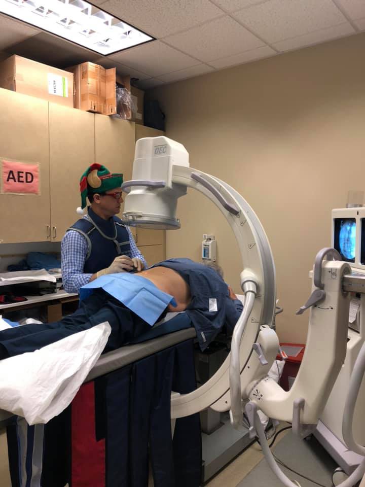 HuffmanClinic's tweet photo. We know the holidays are over, but we had to share this #TBT photo of Dr. Huffman, aka Santa’s Little Helper, is injecting Christmas spirit here at the office today! https://t.co/rEaC9pMpQM