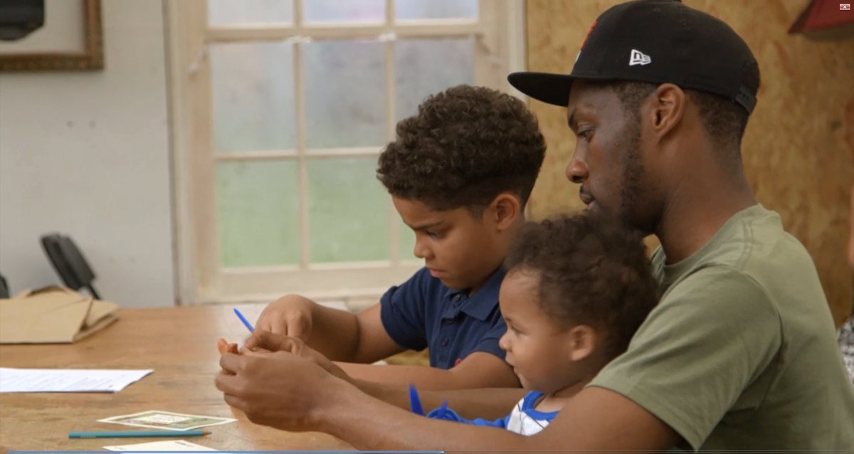 father and sons participate in clay modelling run by UCL at Great Get Together 2019