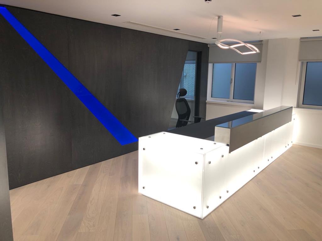 Lignify1's tweet image. Recent installation of light sheet reception desk with sand blasted glass and an additional stained birch plywood feature wall with blue acrylic light box