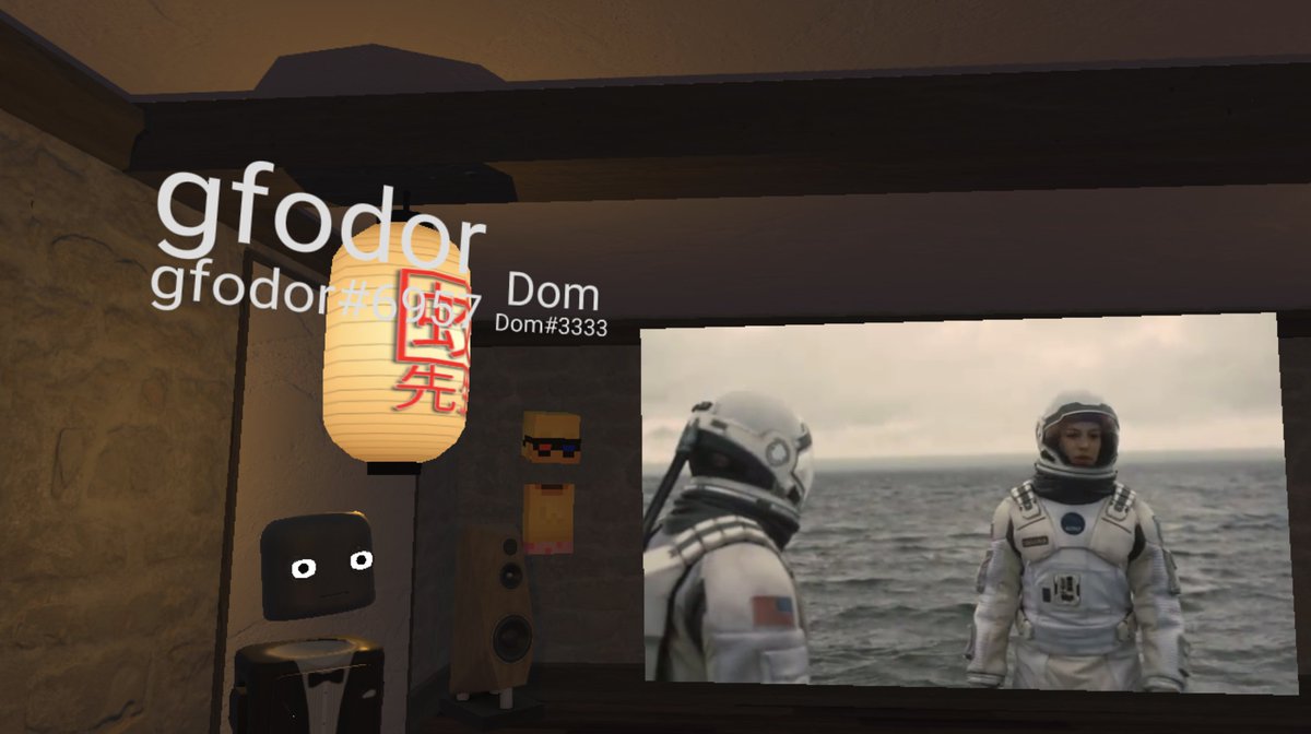 Hubs avatars standing next to astronaut video