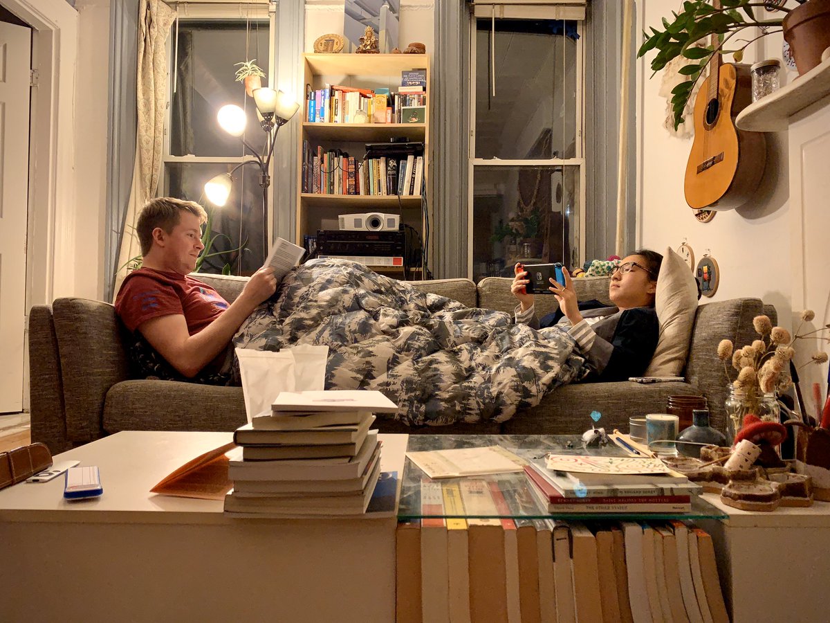 Brendan and Jinjin nestled relaxingly on opposite ends of the couch