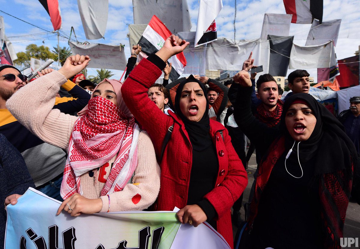 Iraqi anti-government demonstrators carry a national flag as they protest in Baghdad's Tahrir square on Jan. 10, 2020. Thousands of Iraqis rallied across the country today, reviving a months-long protest movement against the government and adding criticisms of both the US and Iran to their chants. Photo by Humam Mohamed/UPI