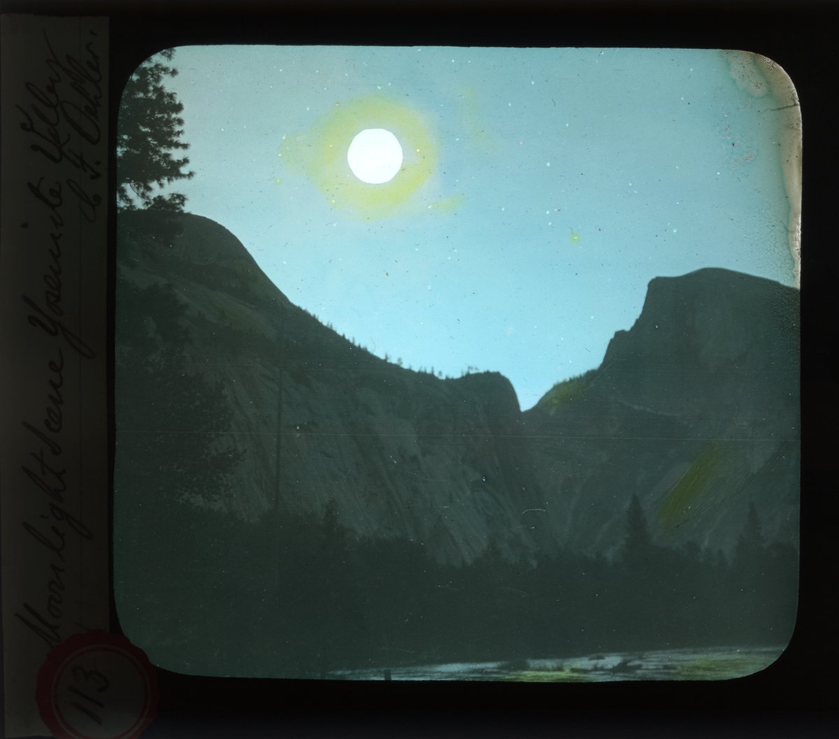 Old slide with view of Half Dome and North Dome under the moon, painted blue