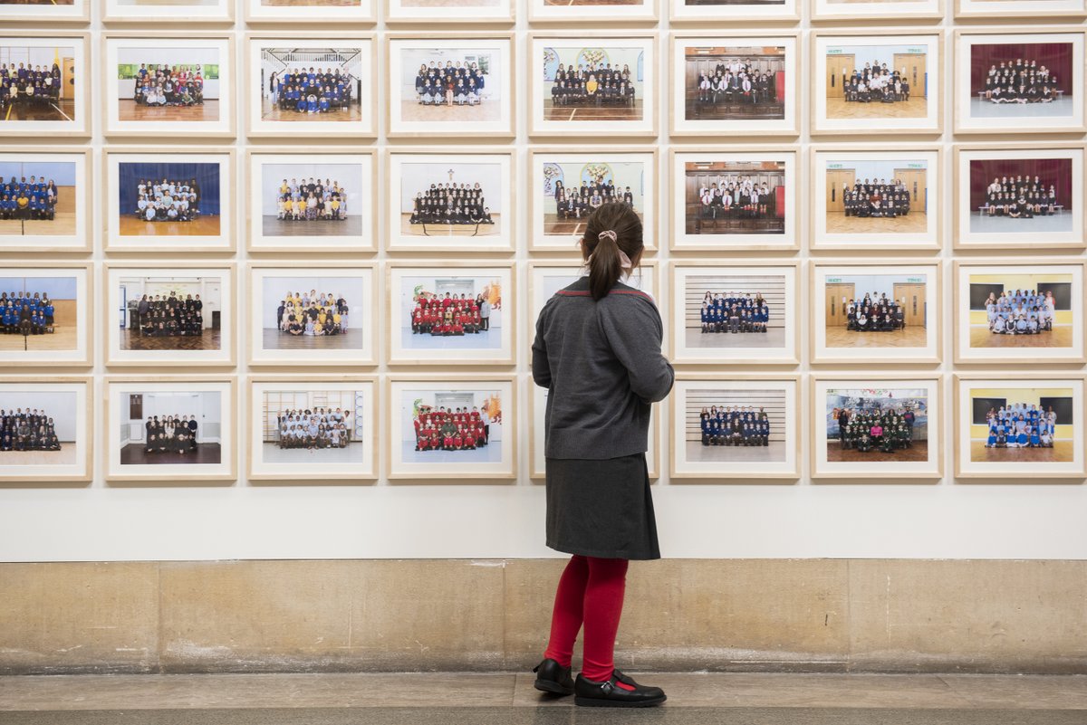 A schoolgirl in Tate Britain's Year 3 Project at Tate Britain looking at her school photo.