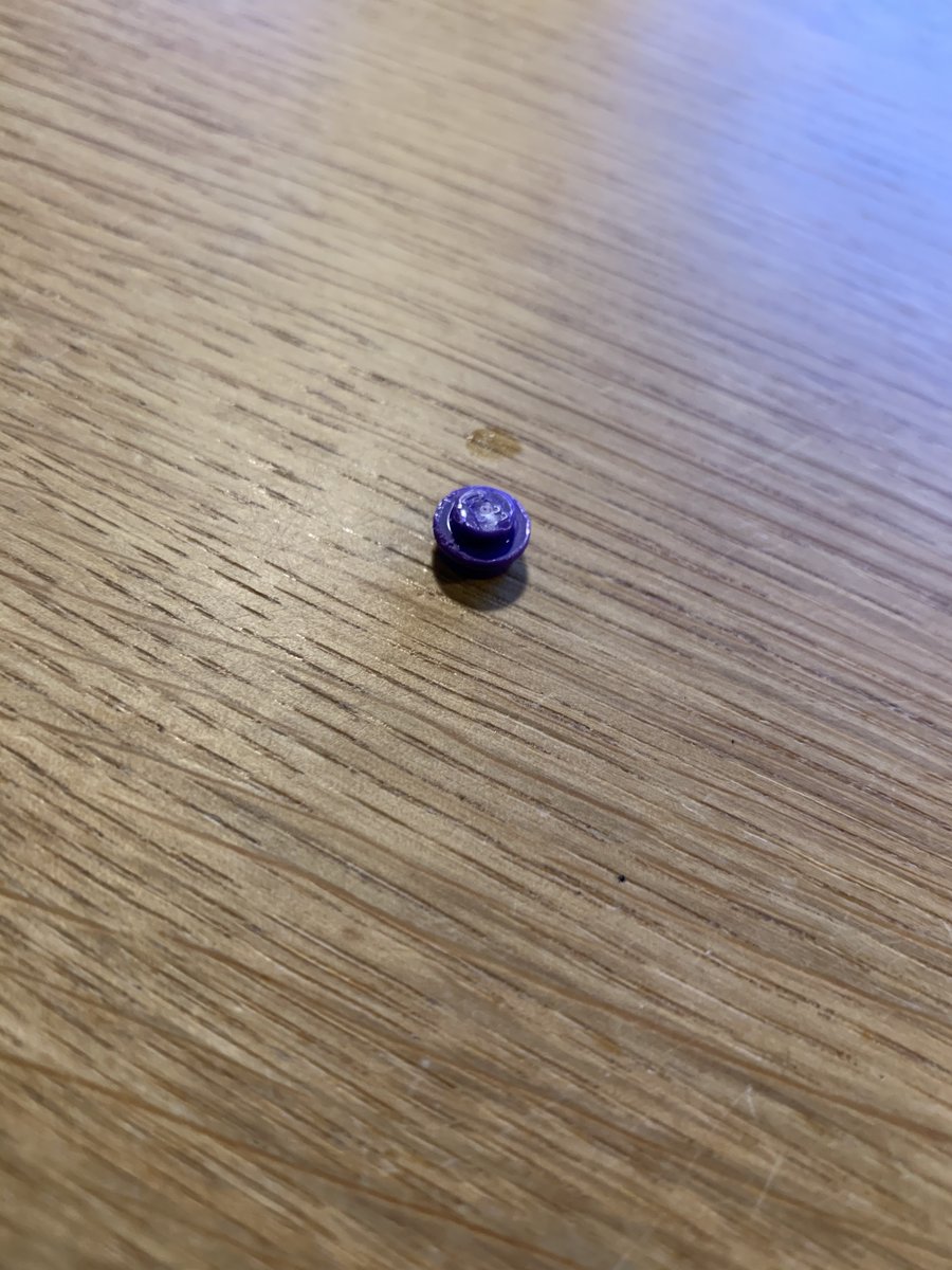 A LEGO 1x1 round plate in purple 