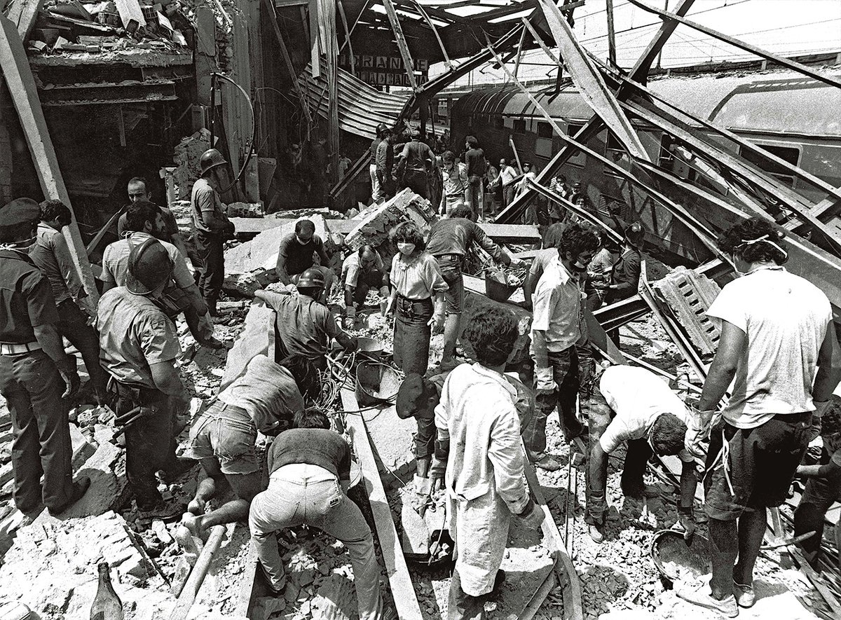 2 August 1980 saw the worst terrorist attack in post-war Italian history. A bomb hidden in a suitcase exploded in the waiting room of Bologna Station, causing partial collapse of structure. 85 people died & 200 were injured. The bomb was planted by neo-fascists of NAR 13.>